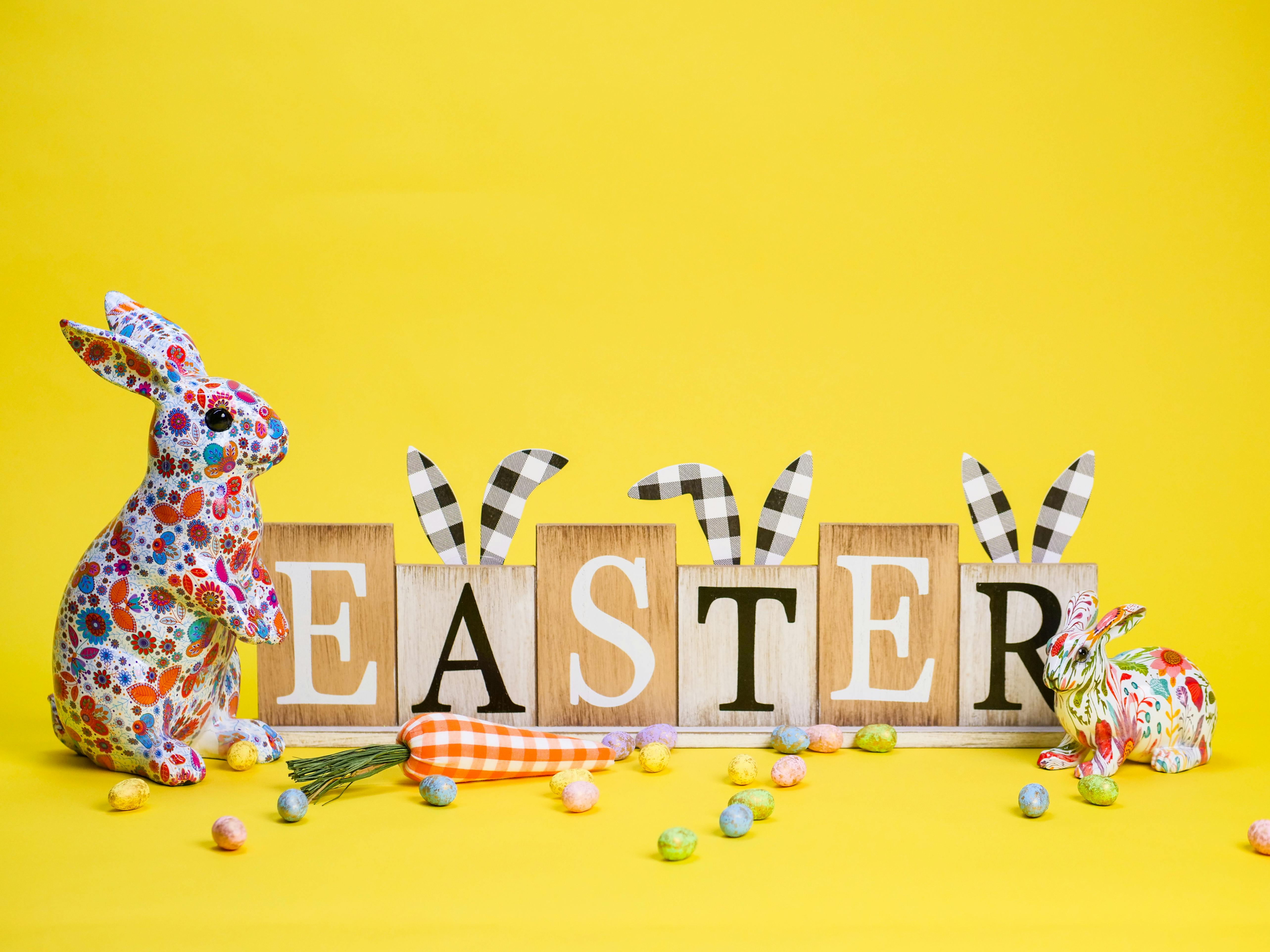Easter rabbit and eggs on yellow background